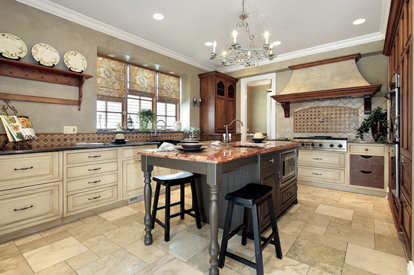 Photo of kitchen with granite counters and a marble island